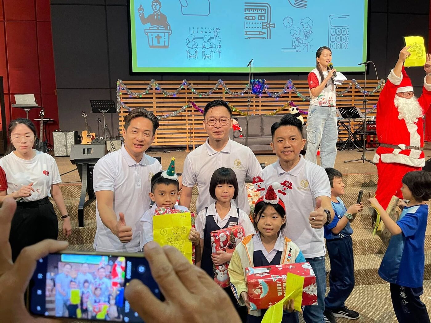 Children receiving Christmas gifts with Santa at Love In Action 2024