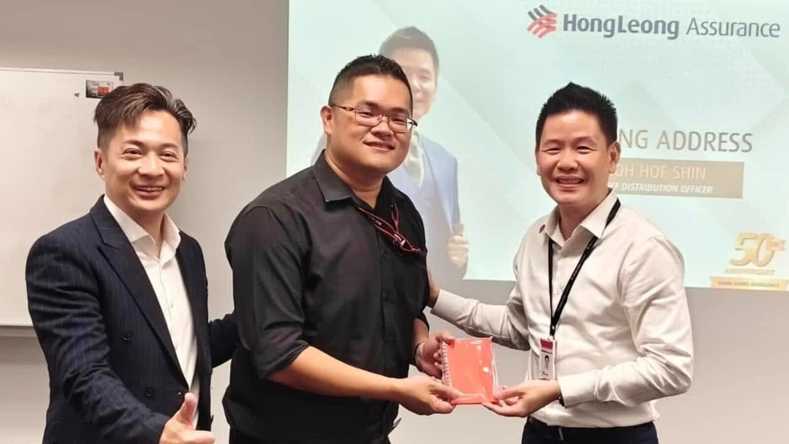 Token handover at the Taylor's University internship programme with Hong Leong Assurance